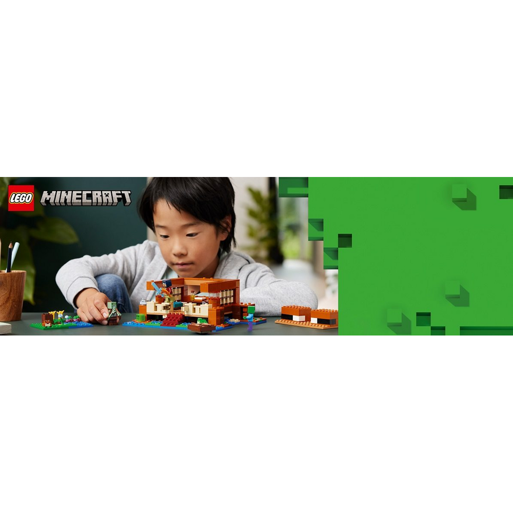 Dítě staví LEGO Minecraft Žabí domek